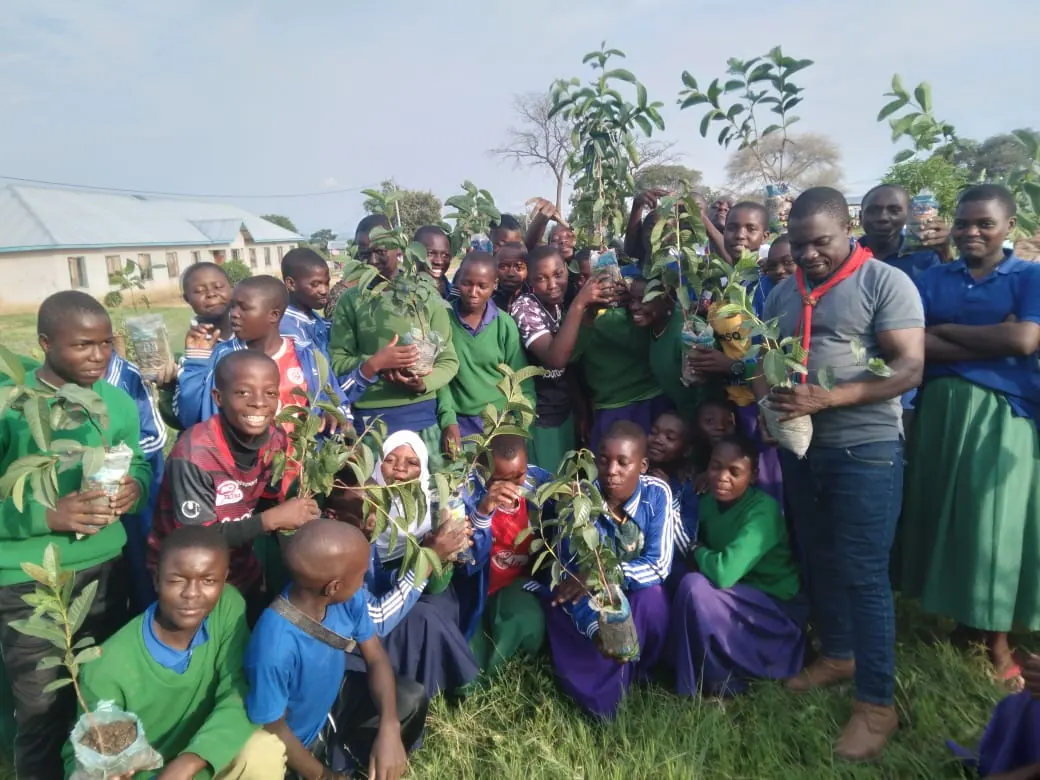 Pupils from a Njombe school holding seedlings they will plant